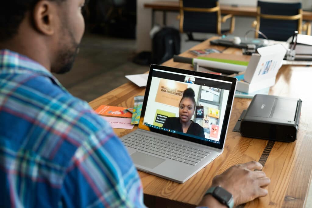 Man and woman interact over a video conferencing call from home