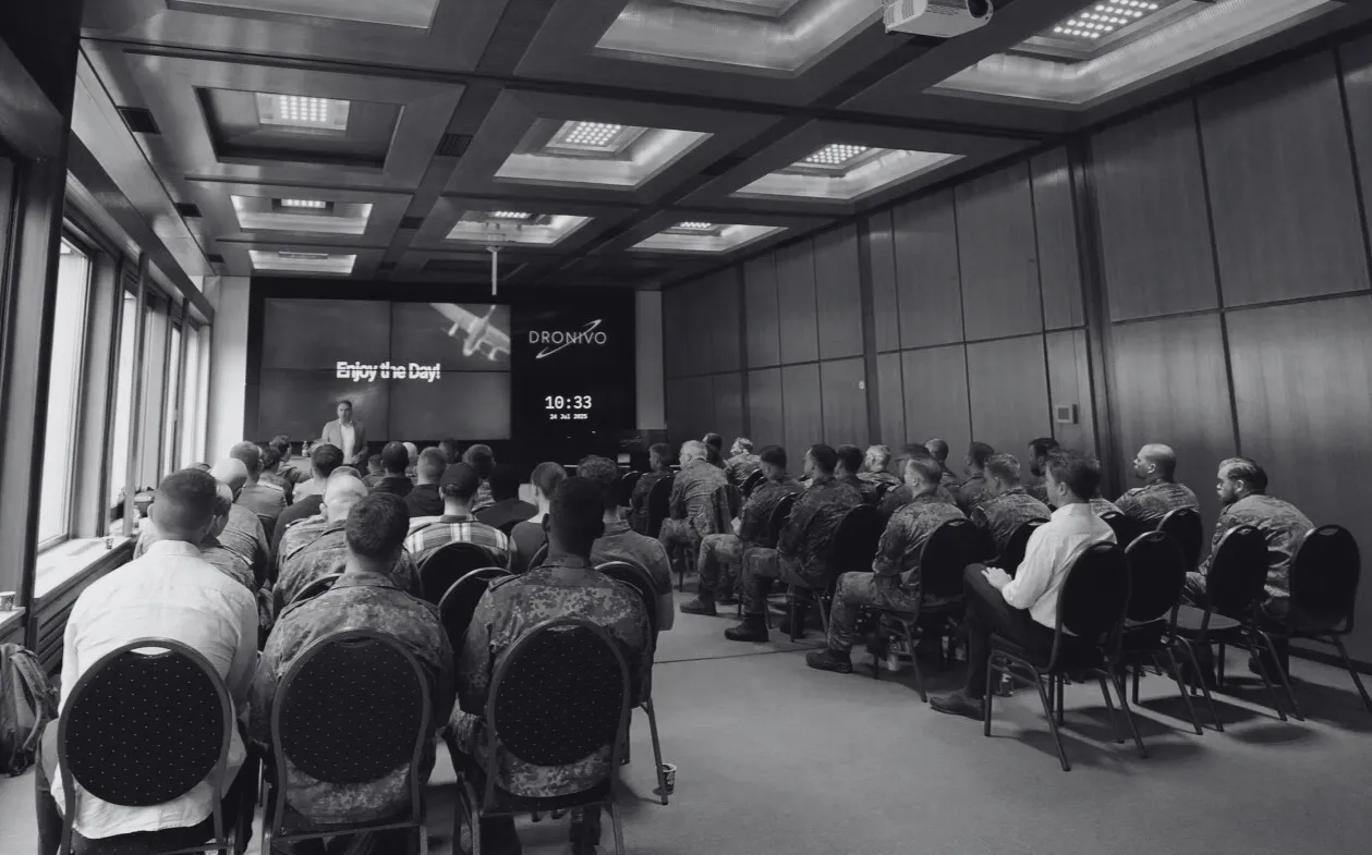 board_room_with_people_facing_screen