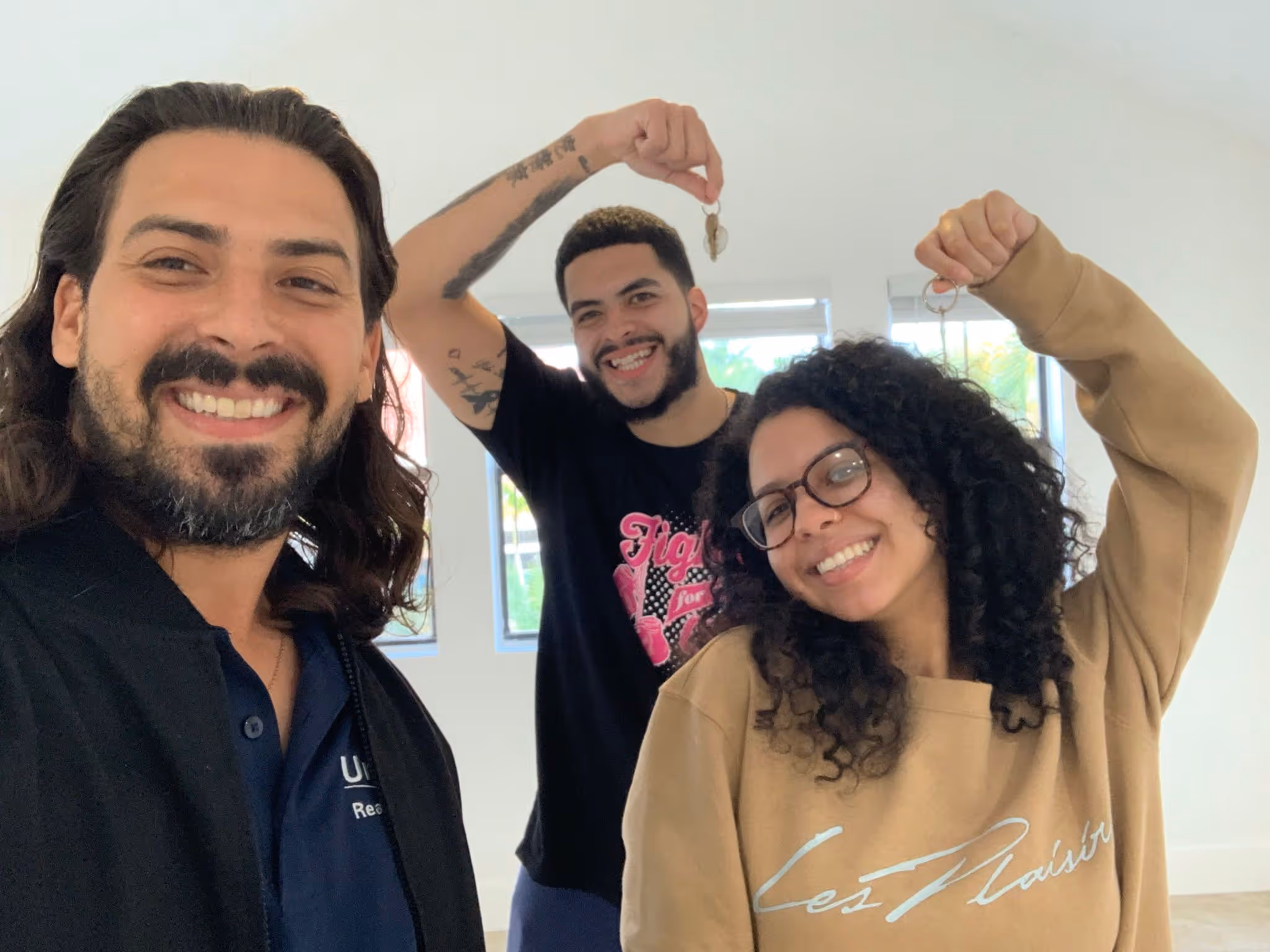 Rudy with Happy new homeowners in their new home