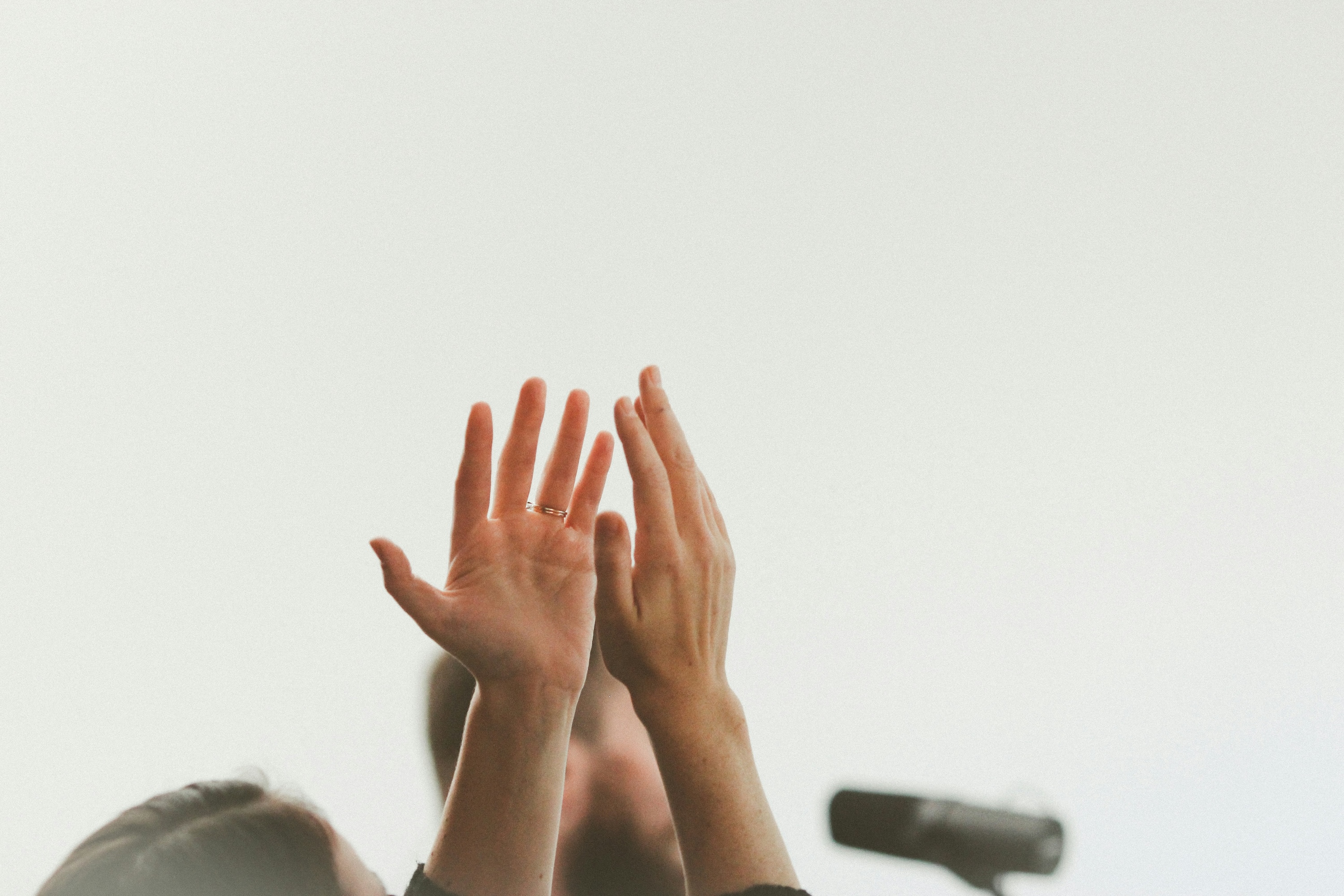hands raised up to the sky