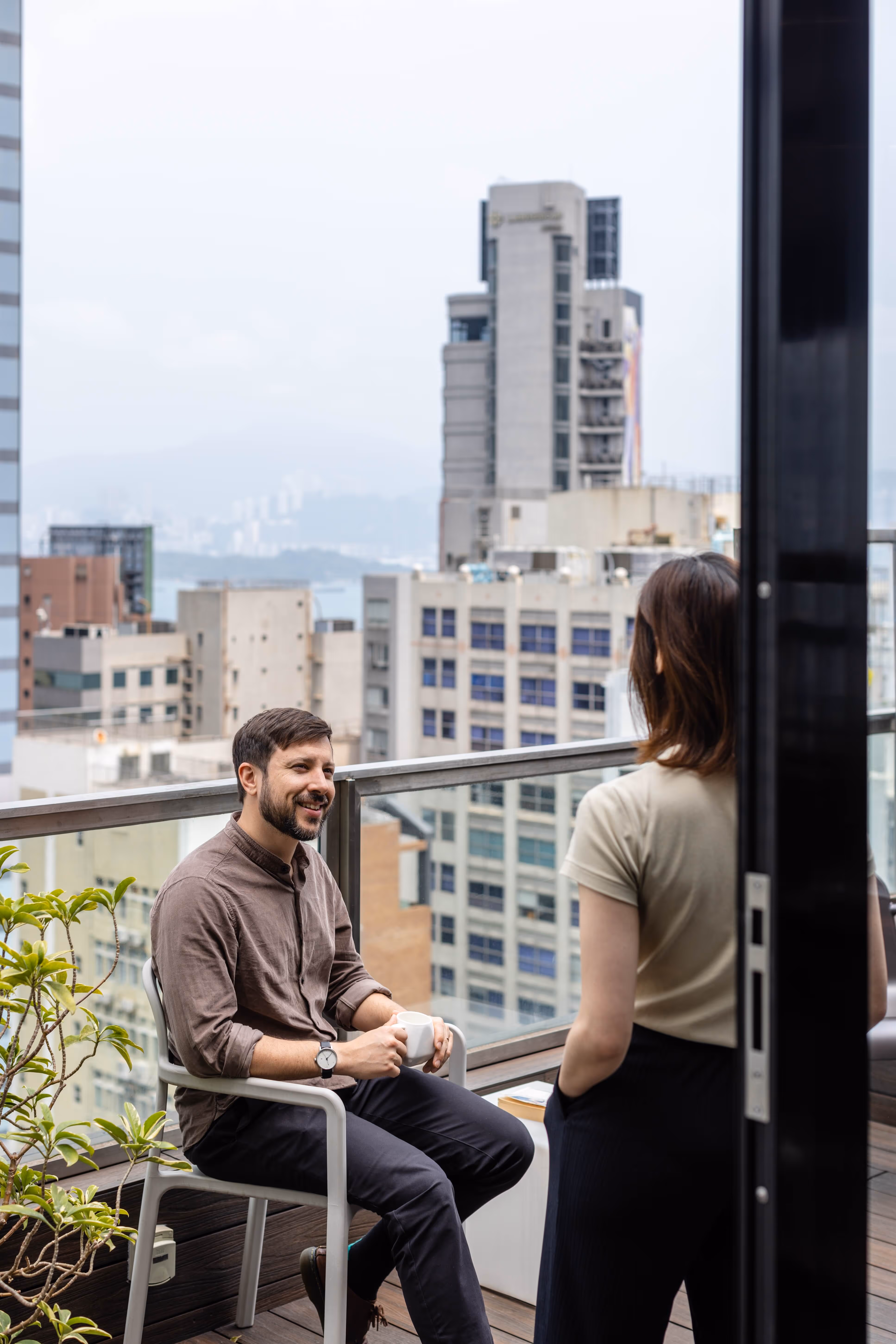 Man on terrace at coworkspace with sea views