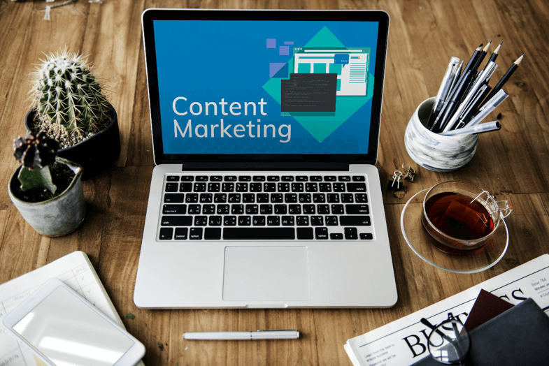 Laptop on desk with content marketing on screen