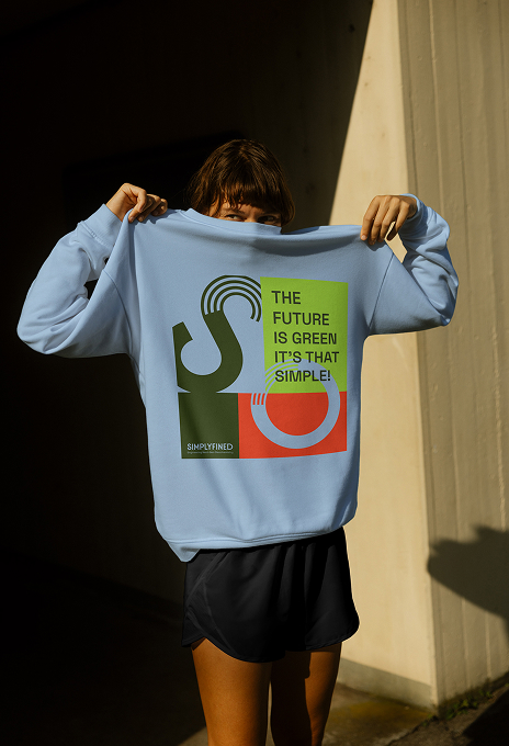 Front view of a person wearing a Simplyfined sweater with the logo and the tagline “The Future is Green. It’s That Simple.”