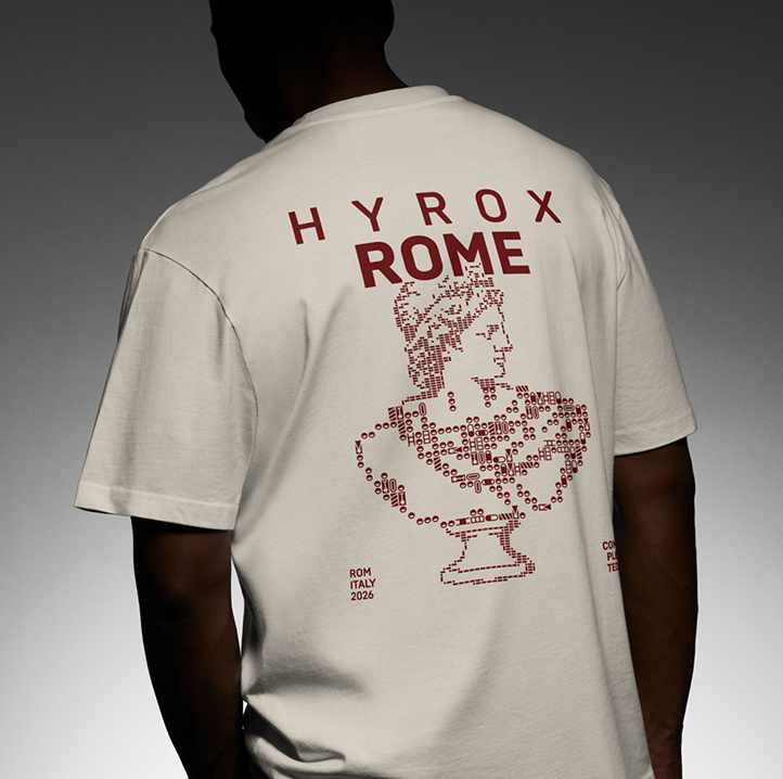 Person seen from the back wearing a yellow t-shirt with red text and design, featuring 'HYROX ROME' and an artistic bust made of HYROX icons, along with the words 'ROM ITALY 2026'.