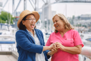 Caregiver and client laughing outside