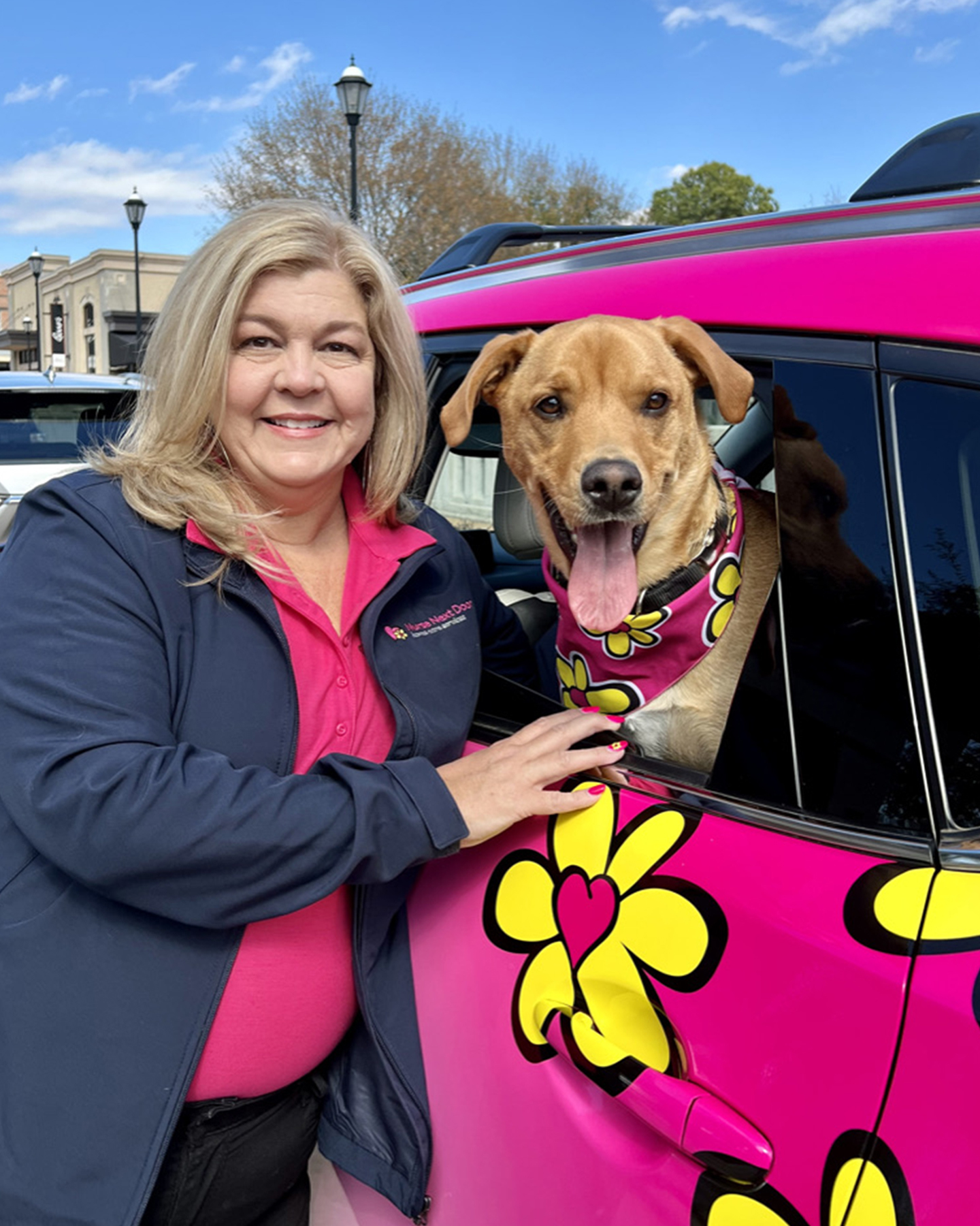 Nurse next door home care franchisee with her dog in front of the car in texas