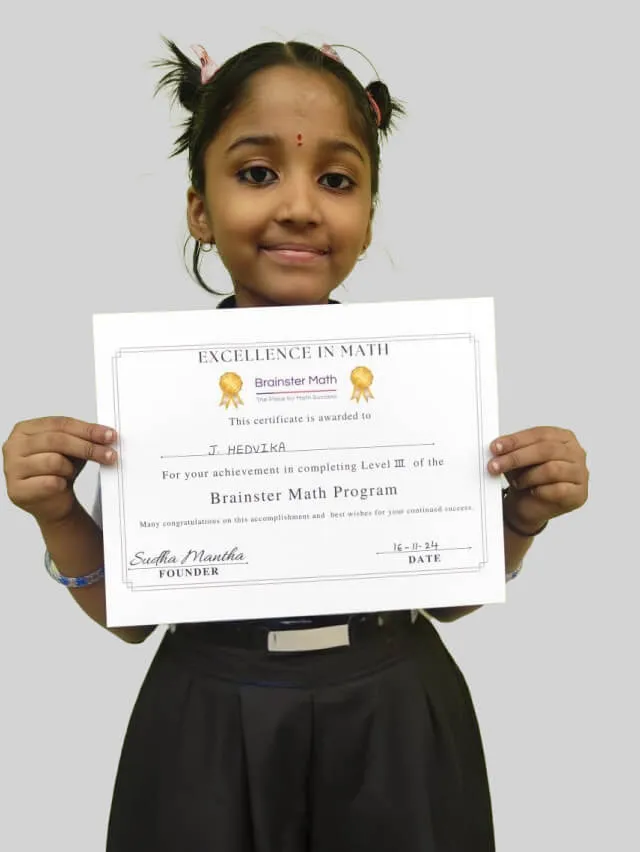 Student proudly holding up a Brainster Math certificate.