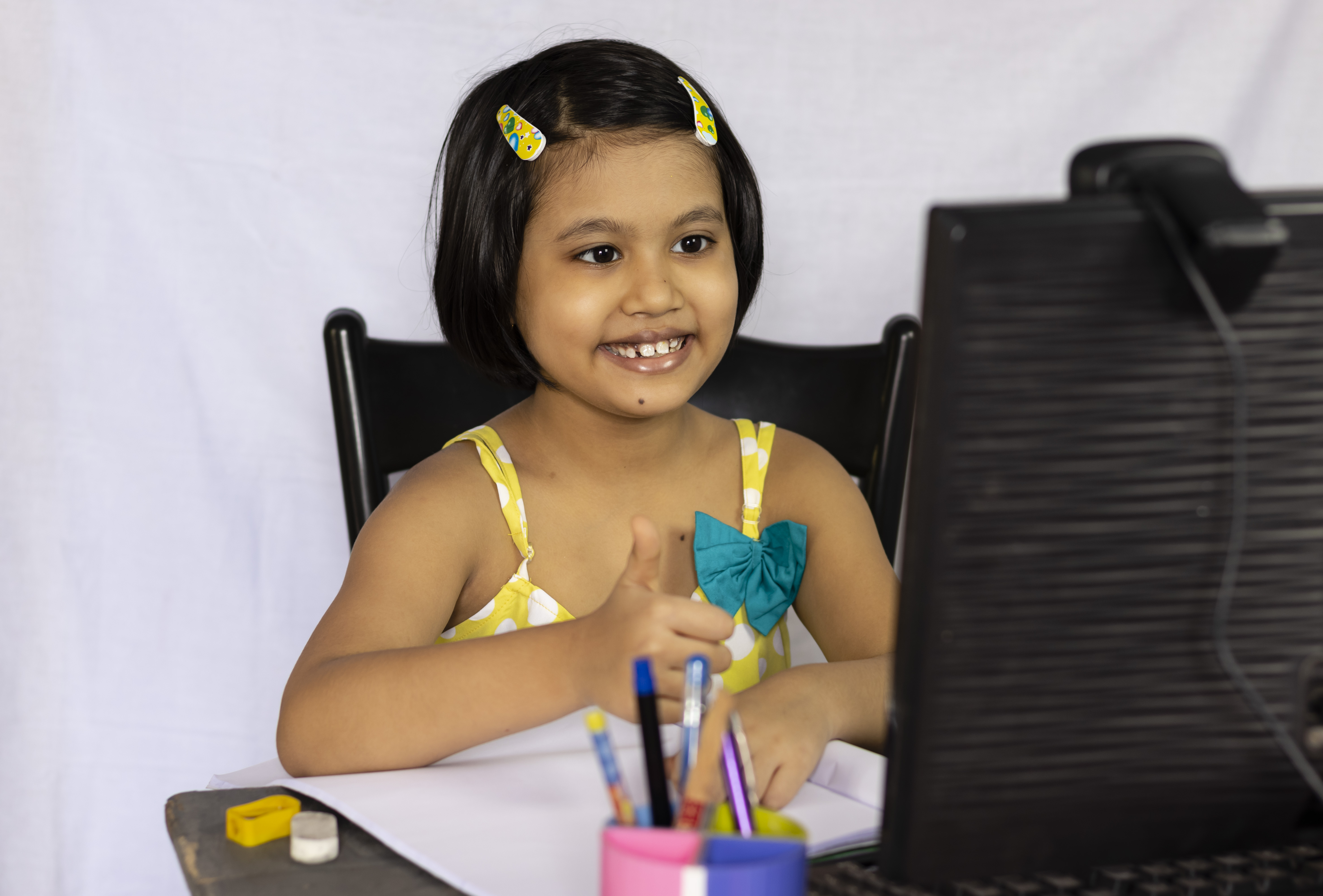 Young child concentrating while doing math for kids exercises on paper.