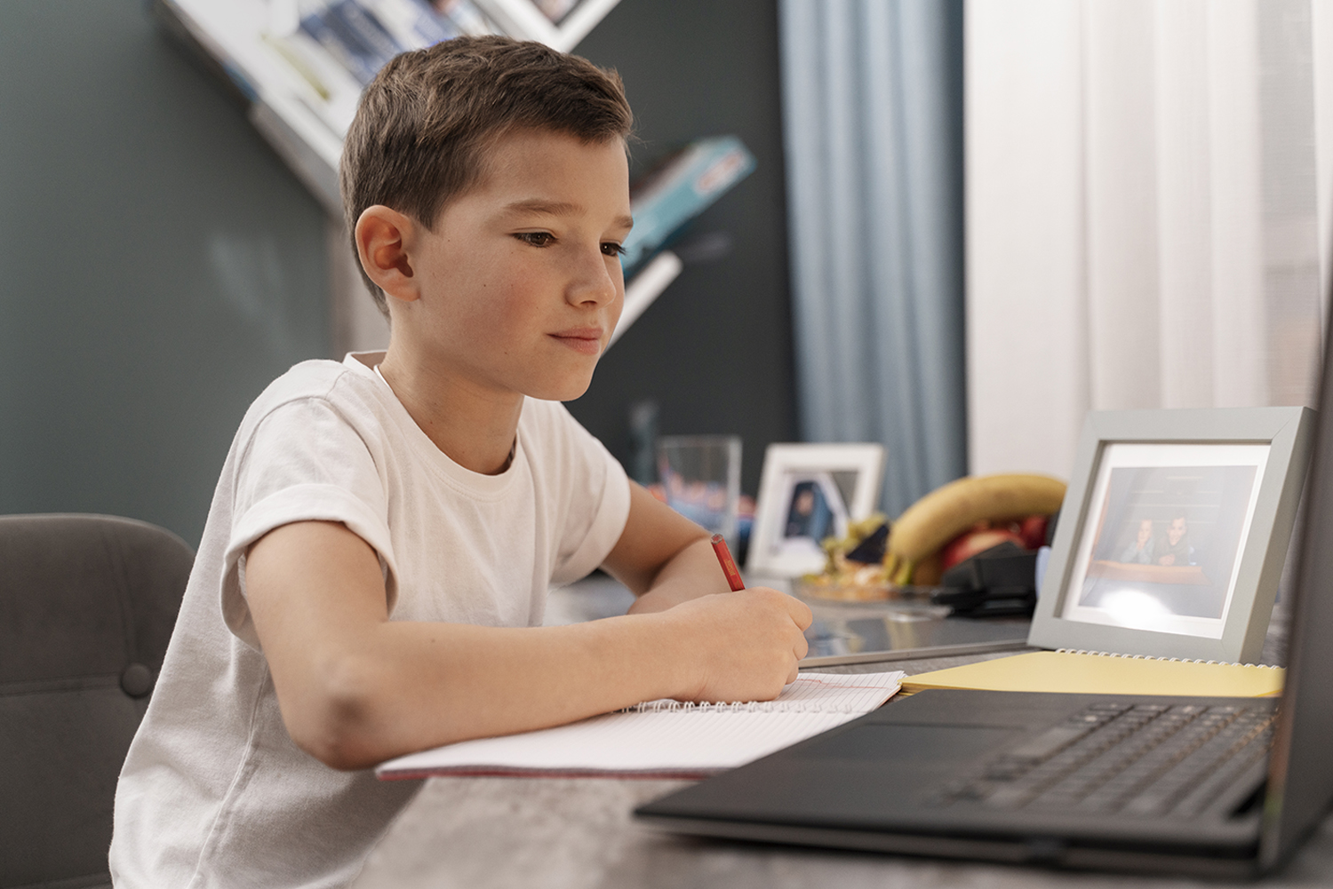 Young child concentrating while doing math for kids exercises on paper.