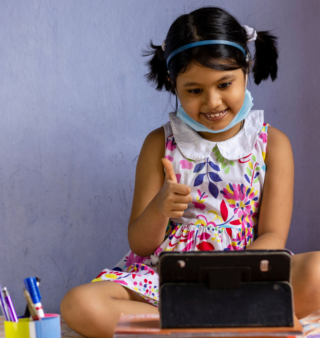 Student using a tablet for kids math tutoring, ready to learn division and statistics in Curriculum Level 5.