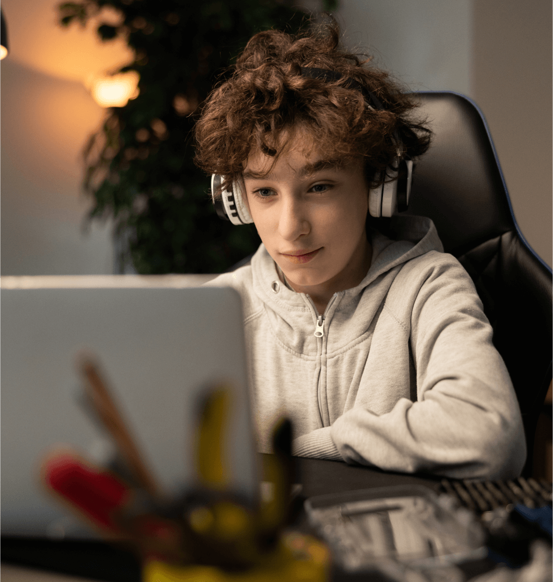 Student with headphones learning algebra concepts via online math tutoring for Curriculum Level 9.