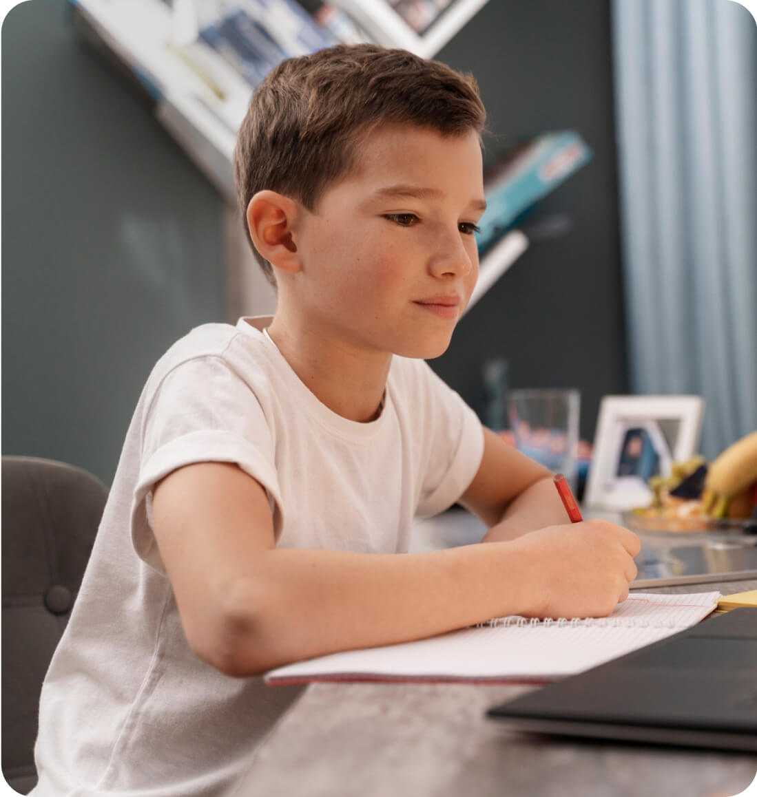 Student taking notes while learning about quadratic equations via online math tutoring for Curriculum Level 12.