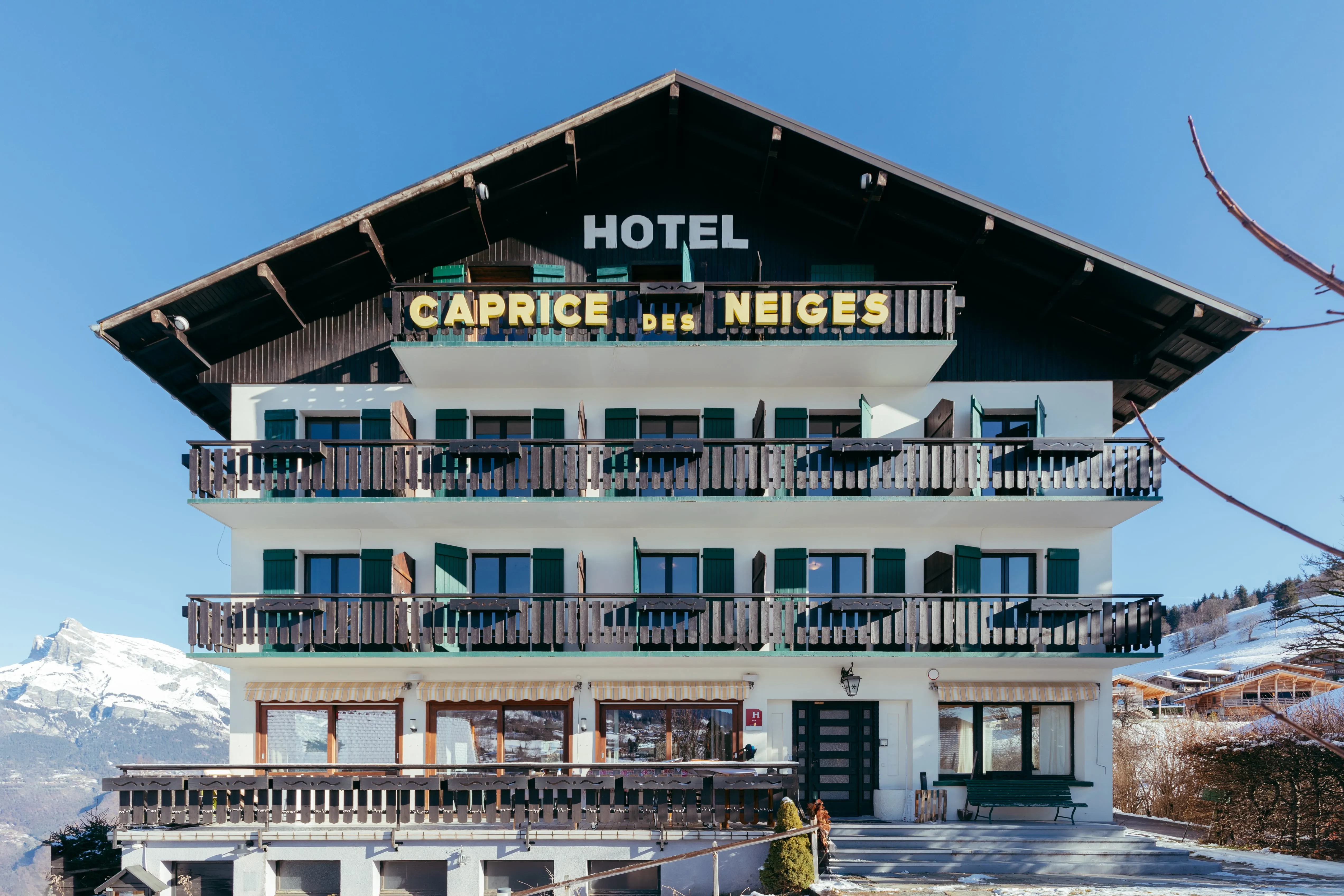 Facade of the Hotel Le Caprice des Neiges, a charming chalet in the hills above Combloux.