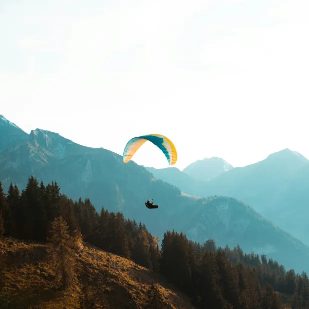 Paragliding flight over Combloux with panoramic views of Mont Blanc.