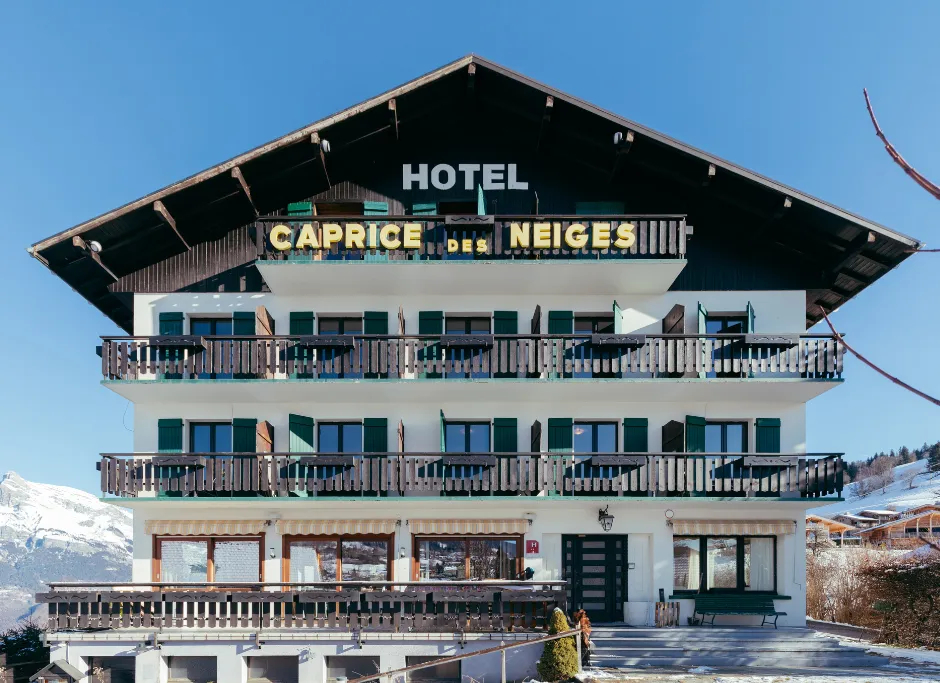 Facade of the Hotel Le Caprice des Neiges, a typical Savoyard wooden chalet in Combloux.