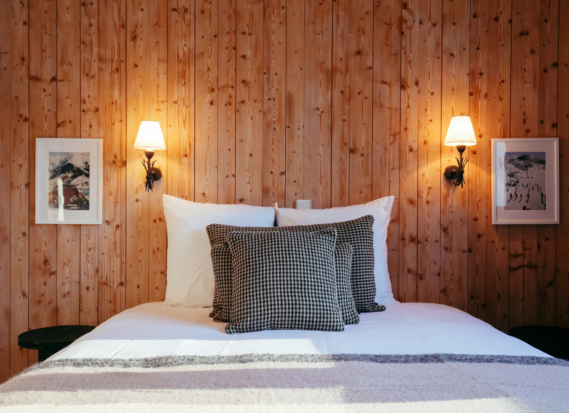 Comfortable bed in a Premium Room at Caprice des Neiges, with its wood and mountain ambiance.