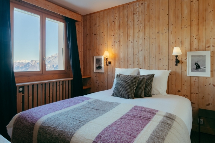 Another view of the Premium Double Room, with its comfortable bed and Alpine decor.