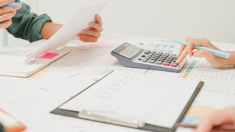 Business owner organizing financial records and receipts - accurate bookkeeping for business growth