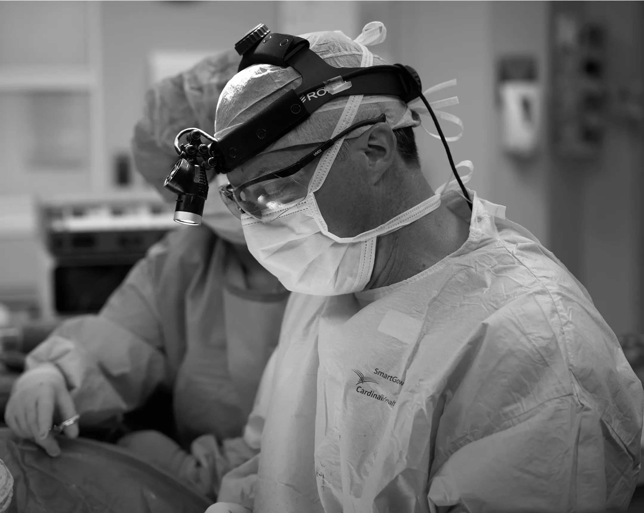 Surgeon performing surgery in a sterile environment.