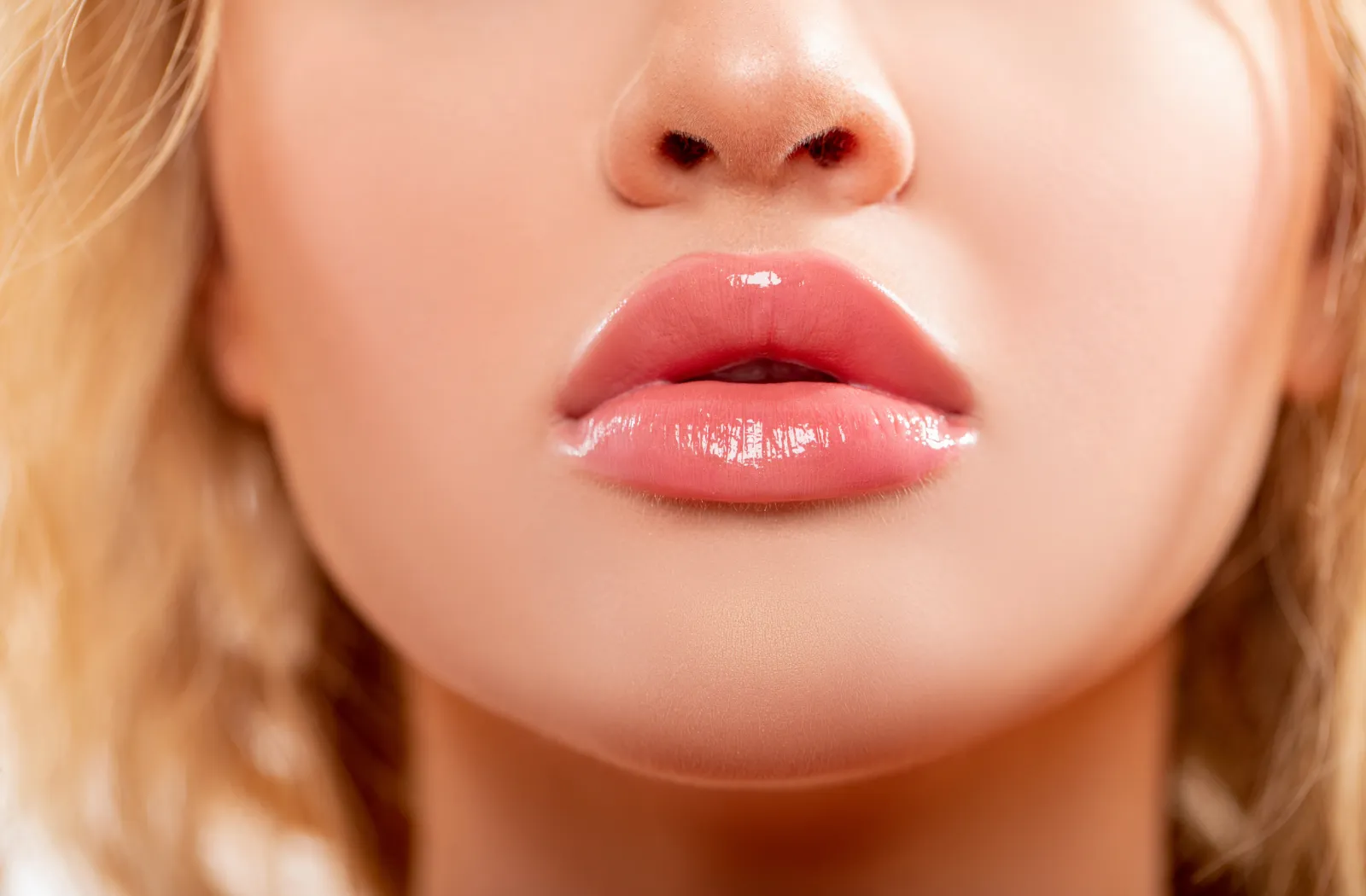 Close-up of a woman's lips with glossy finish.