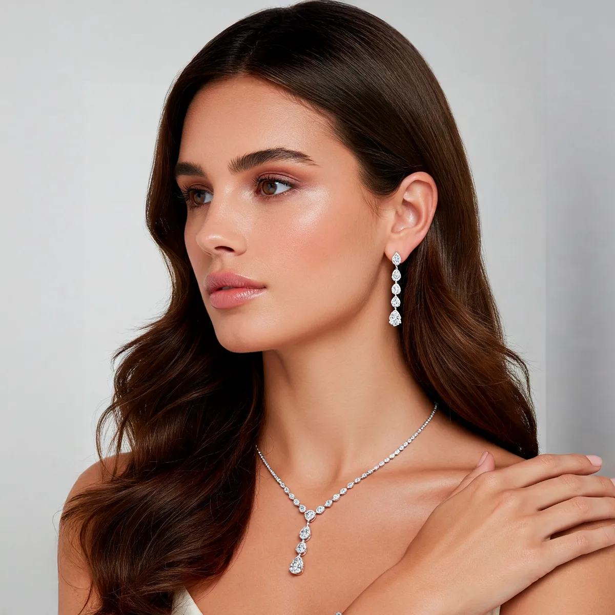 Woman wearing elegant jewelry with earrings and a necklace.