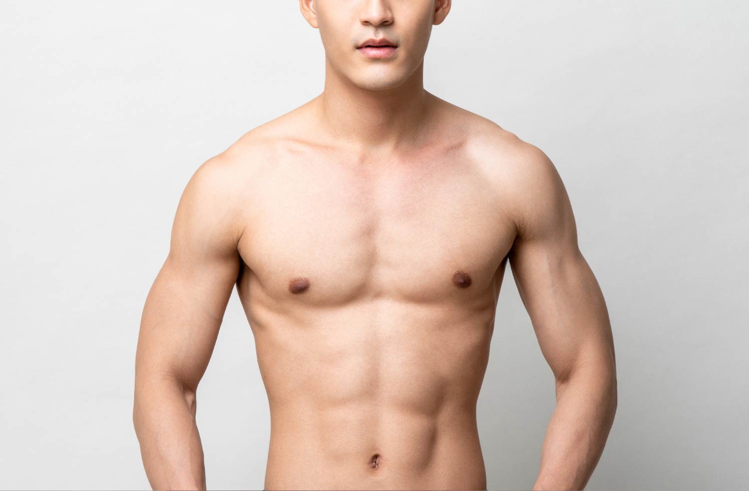 Shirtless man with a muscular chest and arms against a plain white background.