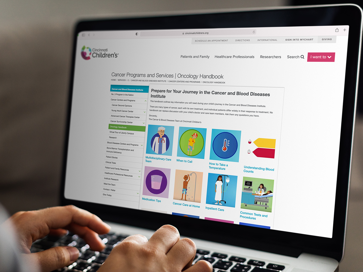 An adult using the digital version of the oncology handbook