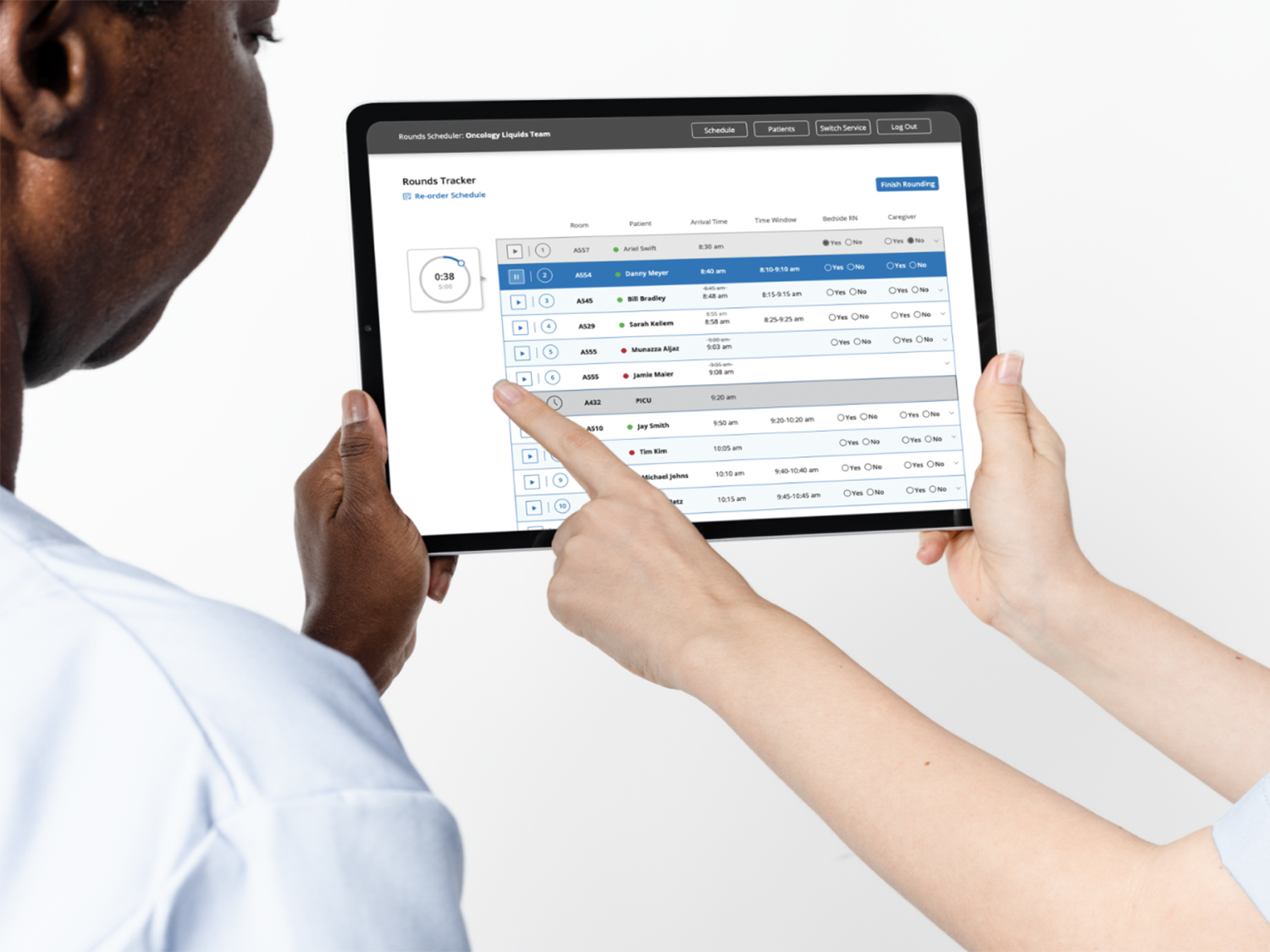 healthcare professionals using the rounds notification app on a tablet