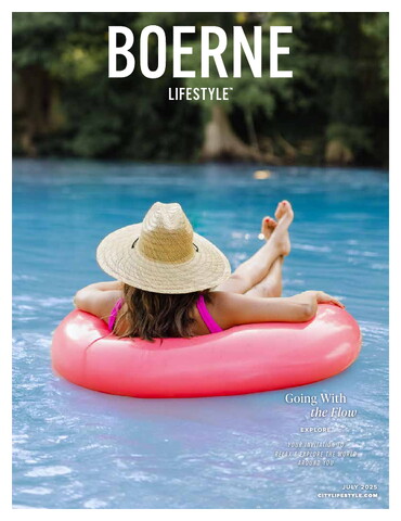 Cover of Boerne Lifestyle, July 2025 issue, featuring a woman lounging on a bright pink inner tube in a clear blue river. She’s wearing a straw hat and a pink swimsuit, floating peacefully with trees and greenery in the blurred background. The headline reads “Going With the Flow.”