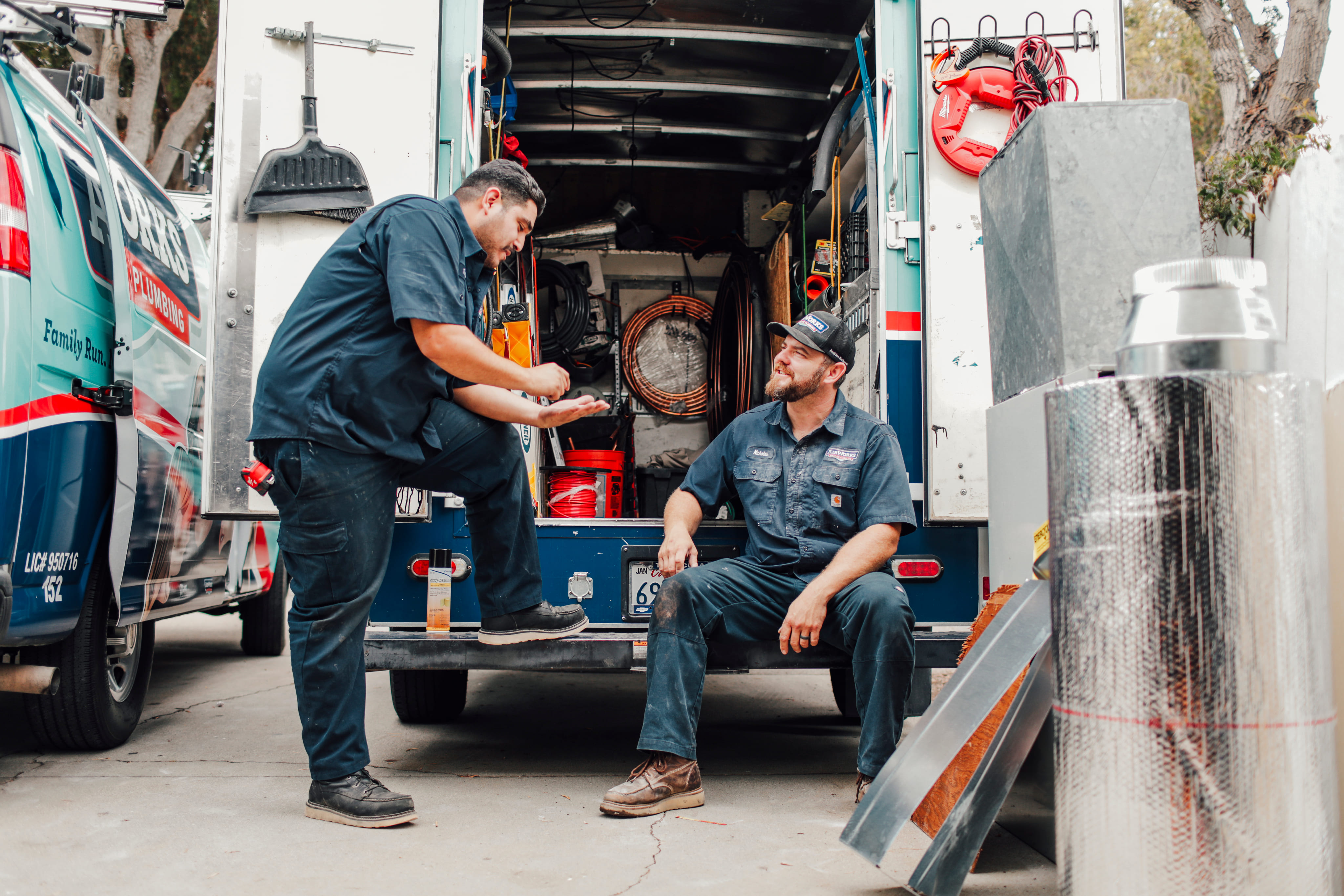 team member resting on a service van