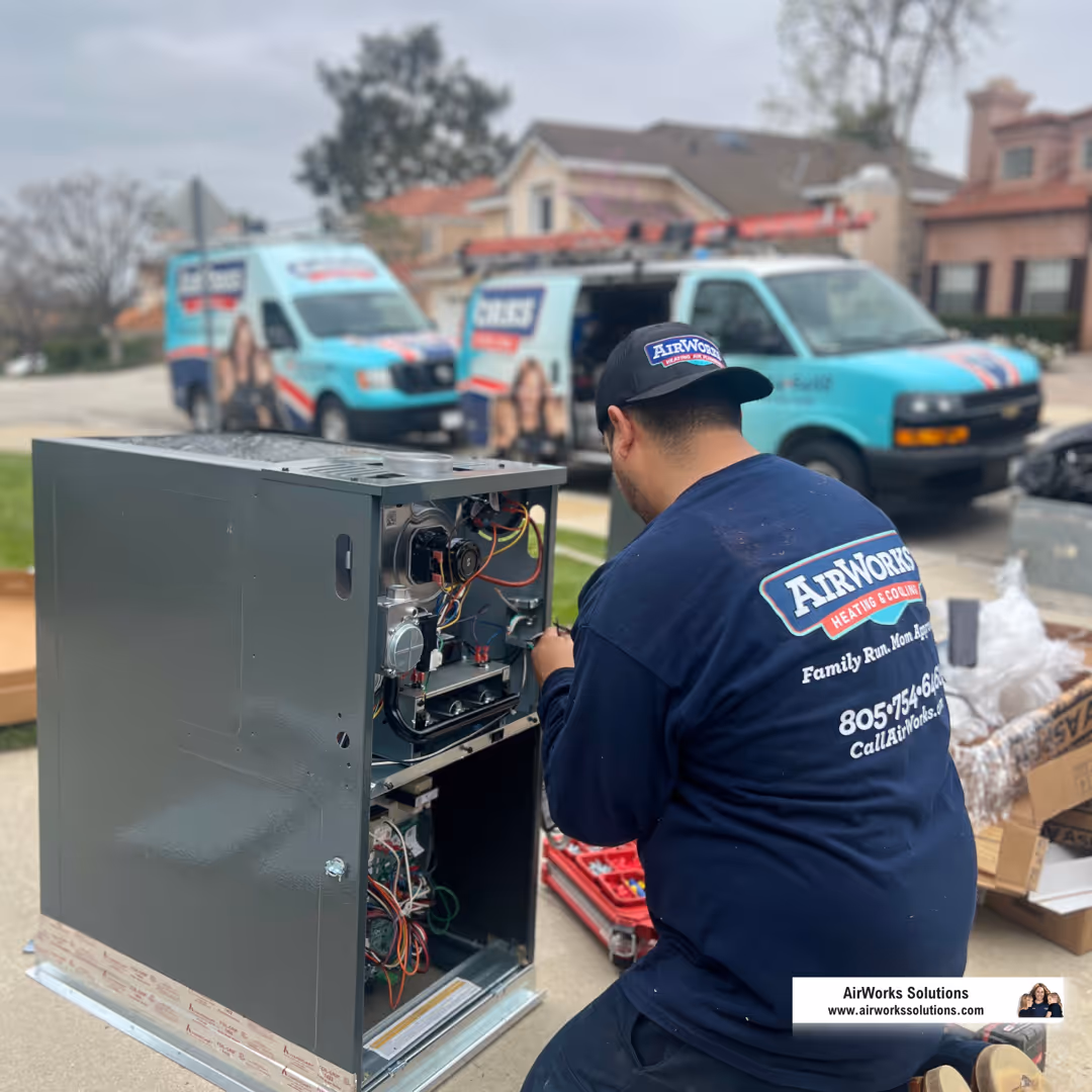 A professional HVAC technician wearing a uniform and holding tools, standing confidently next to a furnace. - furnace repair roseville