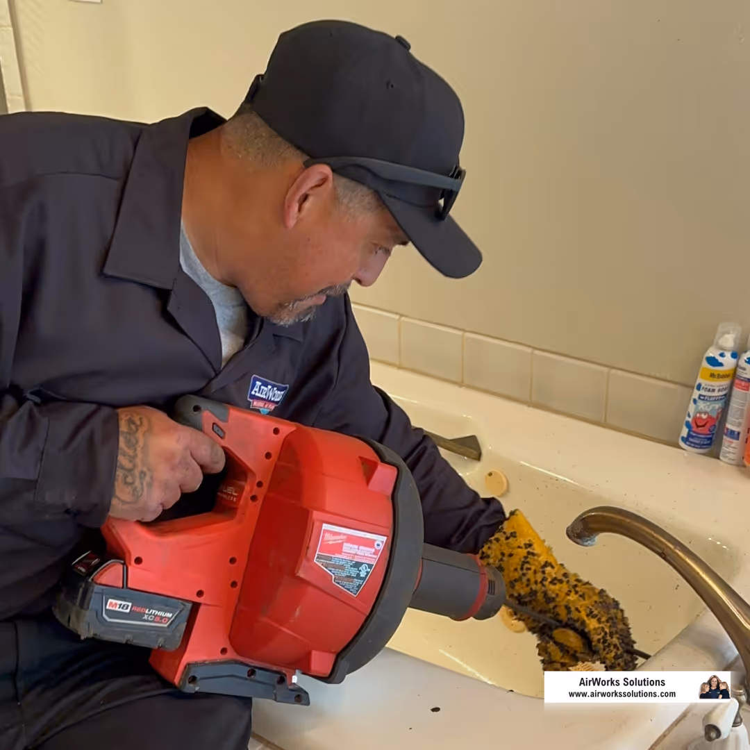 plumber performing maintenance on a water heater - 20 gallon electric water heater