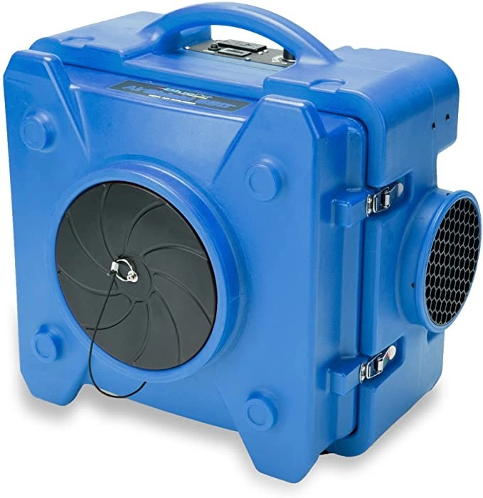 A bright blue, rectangular air scrubber unit with a handle, a black circular fan cover, and a hexagonal mesh air intake vent.