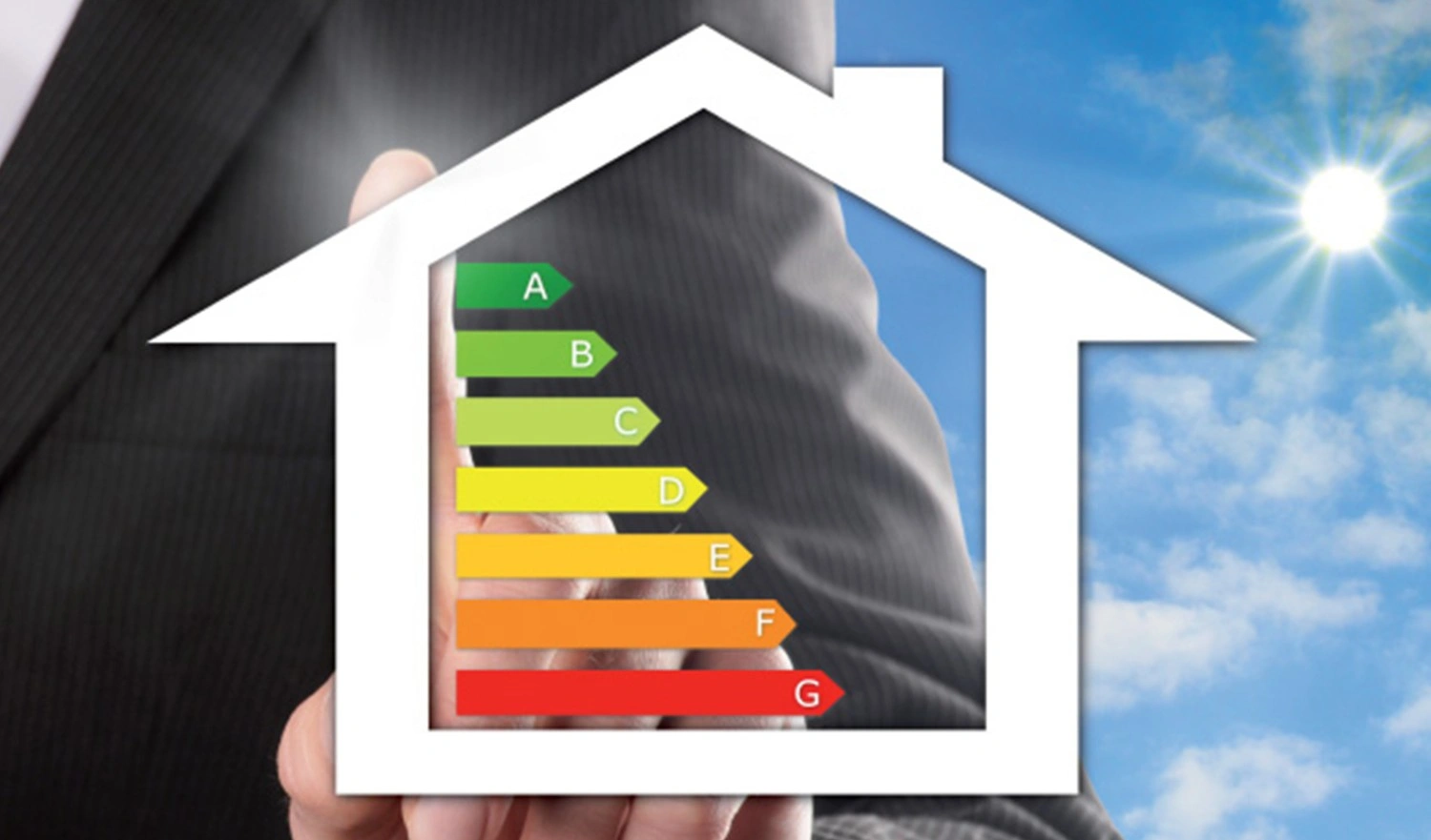 Hand holding house energy efficiency rating.