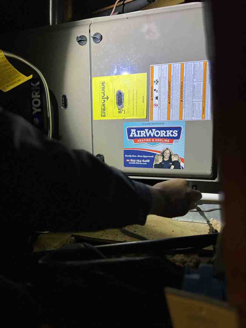 homeowner replacing air filter - hvac repair newbury park ca