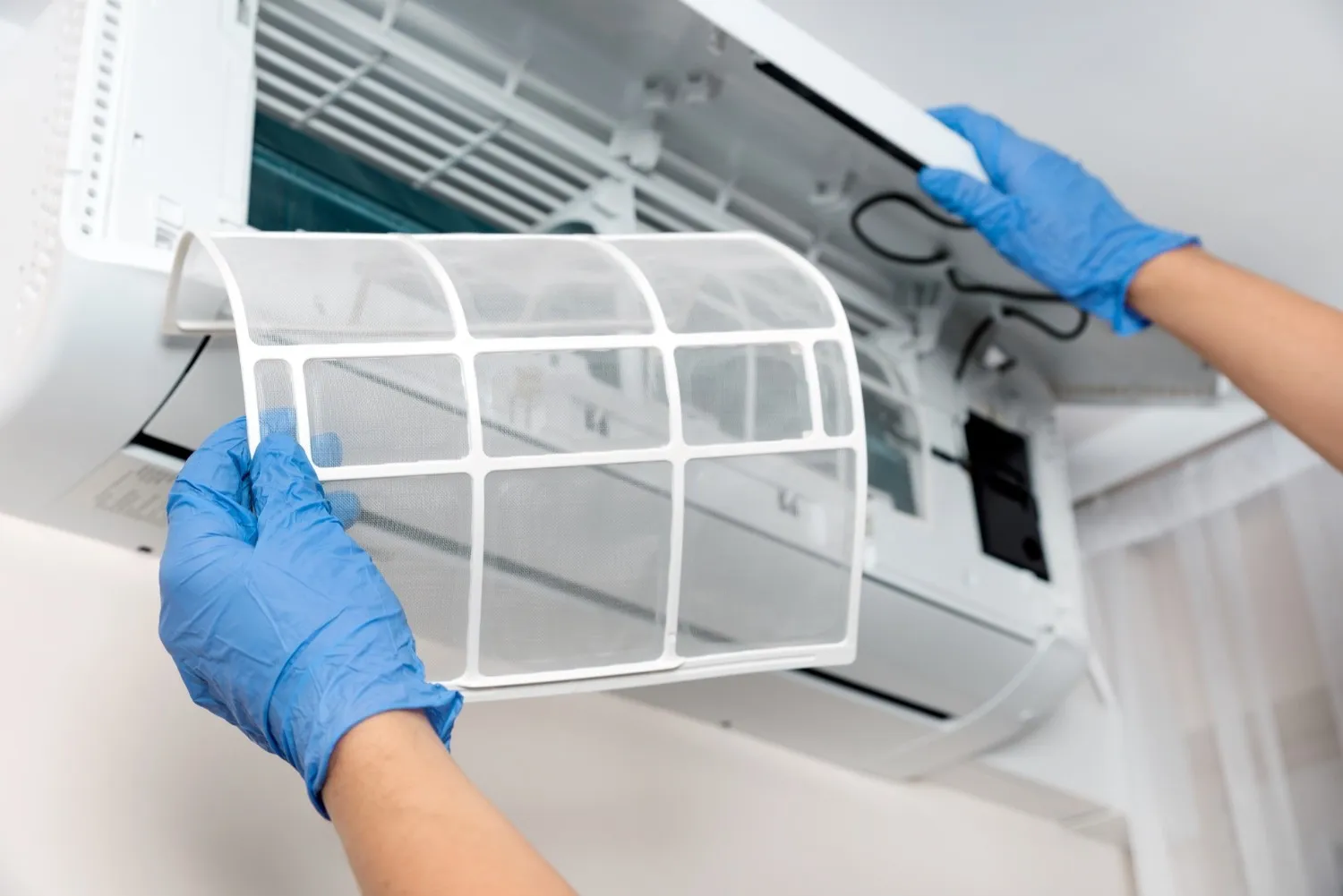 A professional replacing an air filter.