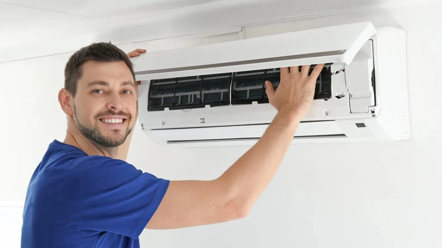 A professional servicing an AC unit.