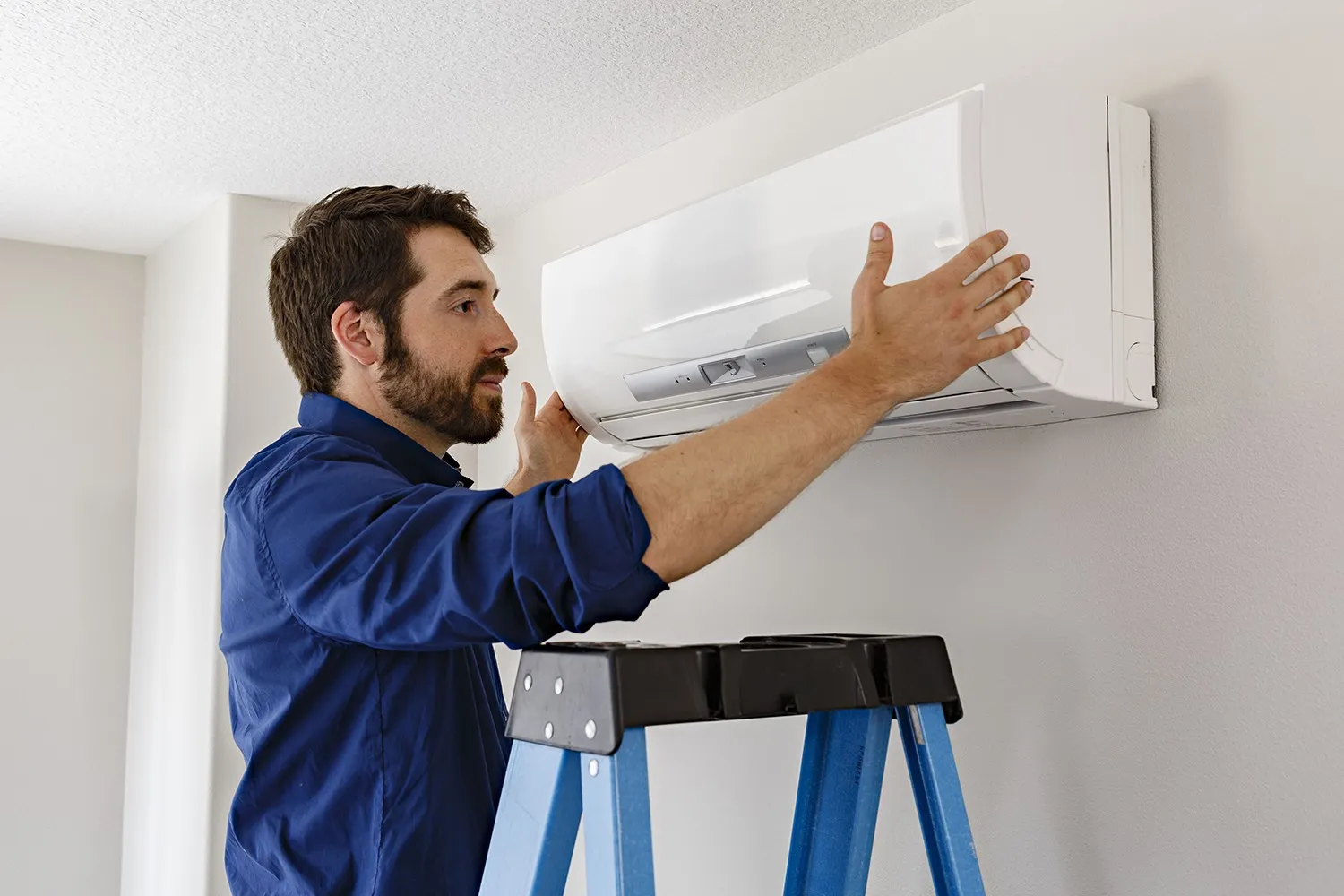 A technician servicing an air conditioner.