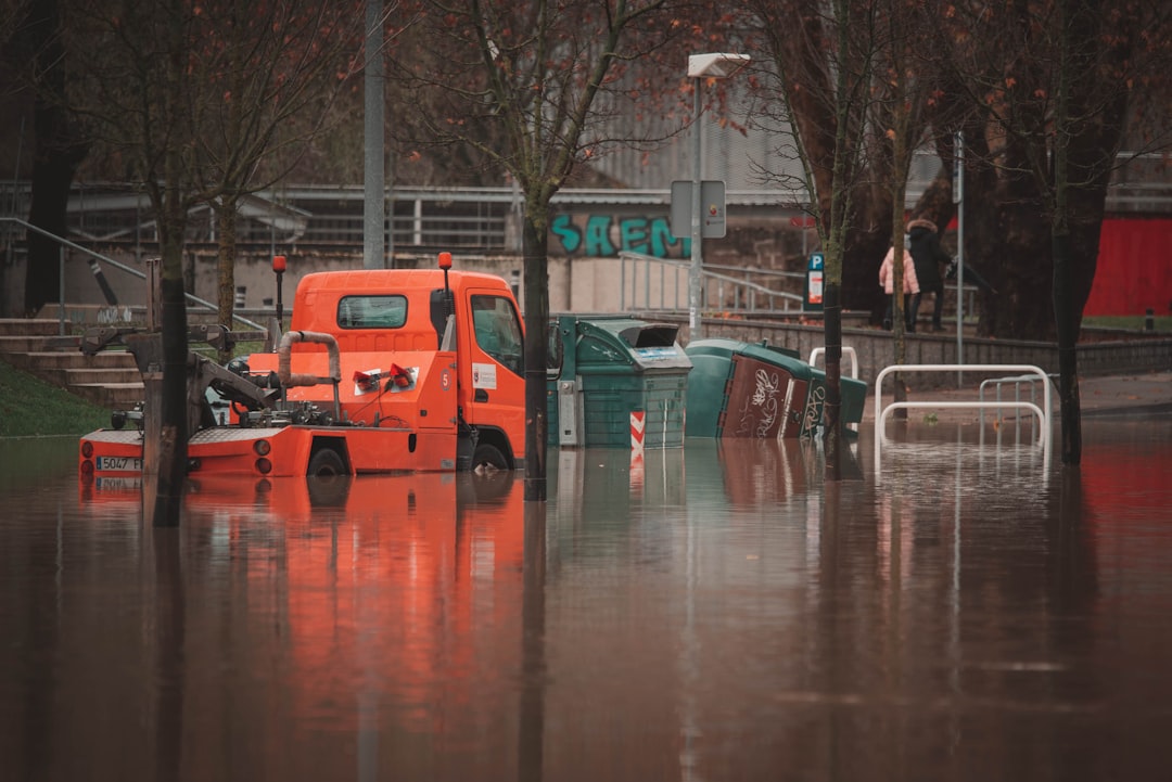 Commercial parking lot with standing water pooled around a clogged storm drain - commercial storm drain cleaning
