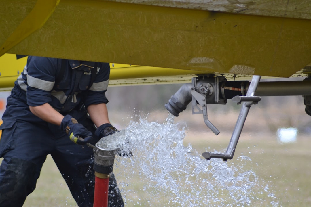 Hydro-jetting truck and technician working on a commercial storm drain - commercial storm drain cleaning