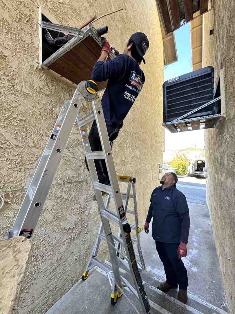 professional technician carefully installing a new air conditioner - ac installation calabasas ca