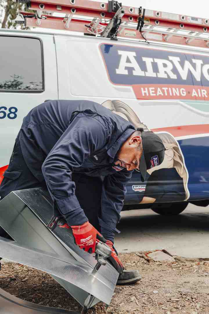 technician using a high-powered vacuum hose on an air duct - duct cleaning thousand oaks ca