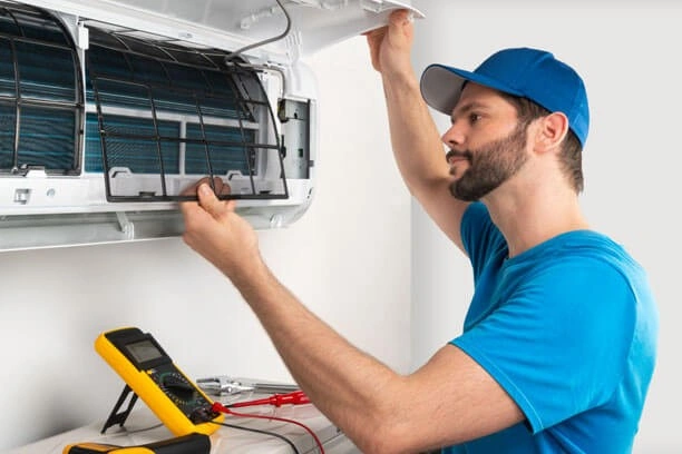 Technician inspecting filter of mini-split AC unit