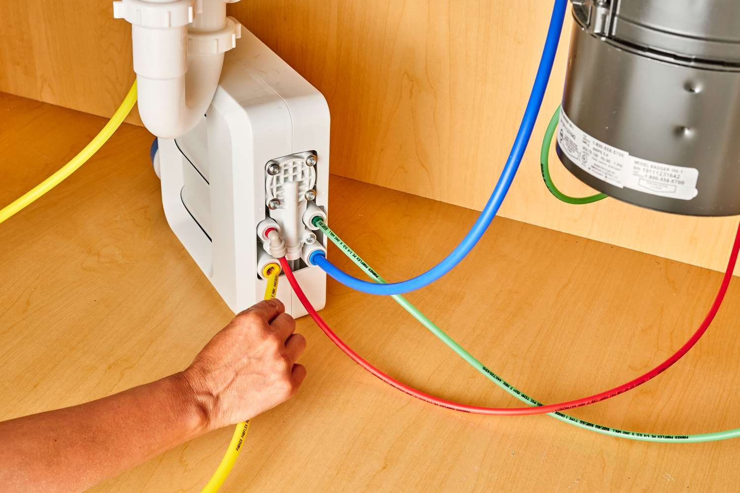 Connecting colored tubes to RO system.