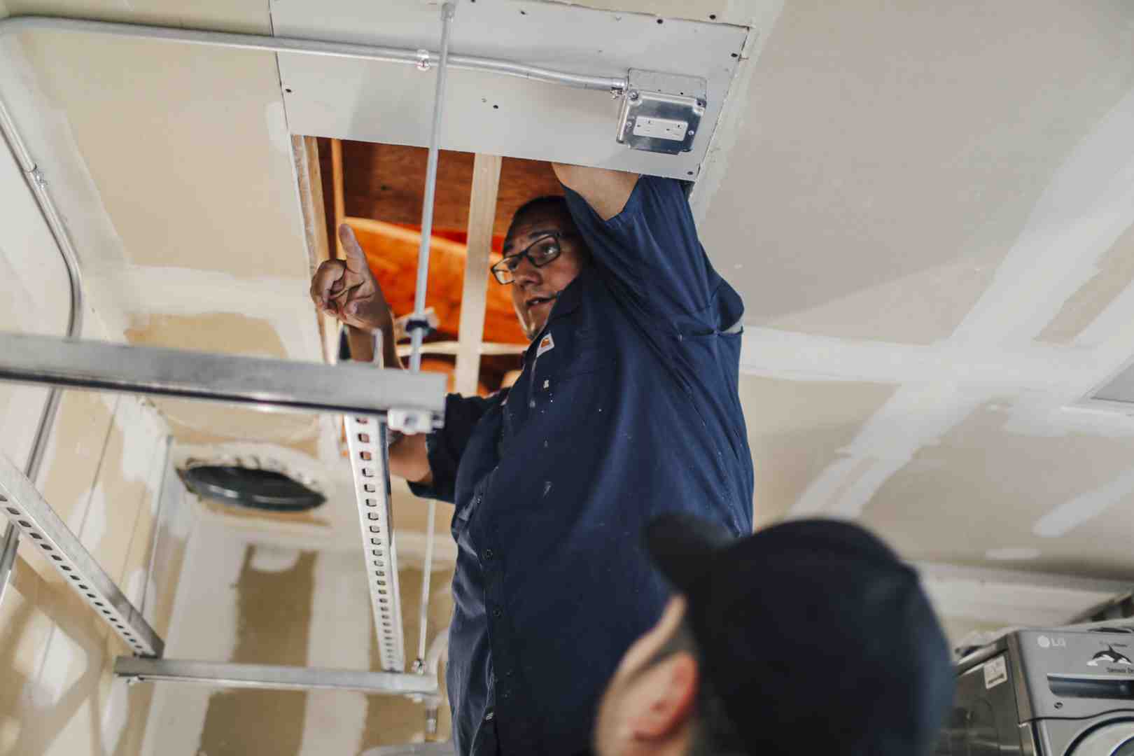 a licensed electrician inspecting an electrical panel - "Which companies in the Sacramento area specialize in whole home generators installation?" a licensed electrician inspecting an electrical panel - "Which companies in the Sacramento area specialize in whole home generators installation?"
