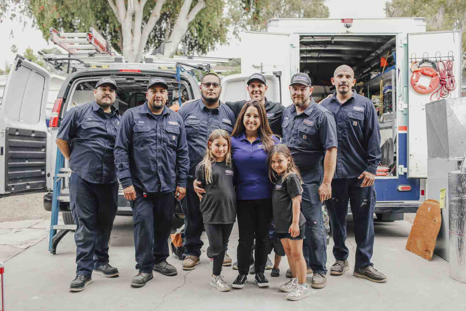 a professional HVAC team standing proudly next to their service van with tools and equipment - furnace installation camarillo ca