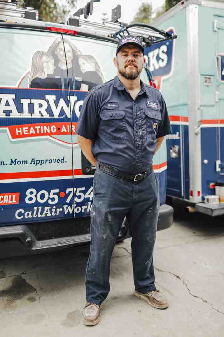 friendly technician arriving at a home in a service van - emergency hvac repair newbury park ca