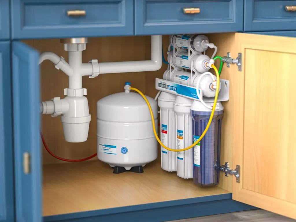 Under-sink reverse osmosis water filtration system with multi-colored tubing and a white pressurized storage tank