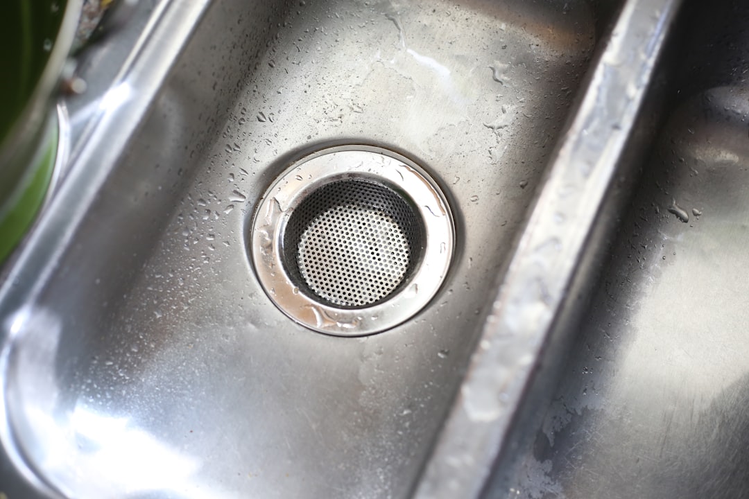 homeowner installing drain strainer in kitchen sink - plumbing repair ventura county homeowner installing drain strainer in kitchen sink - plumbing repair ventura county