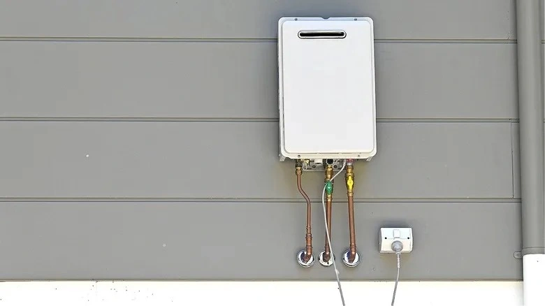 Outdoor tankless water heater on wall.